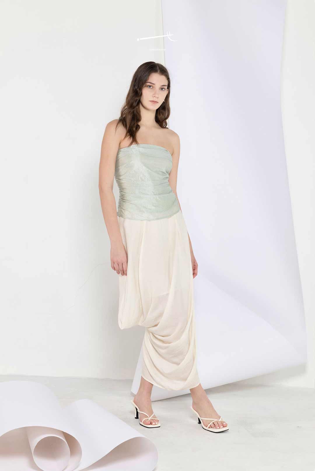 Model wearing Mediterranean-inspired
strapless top and skirt set draped texture