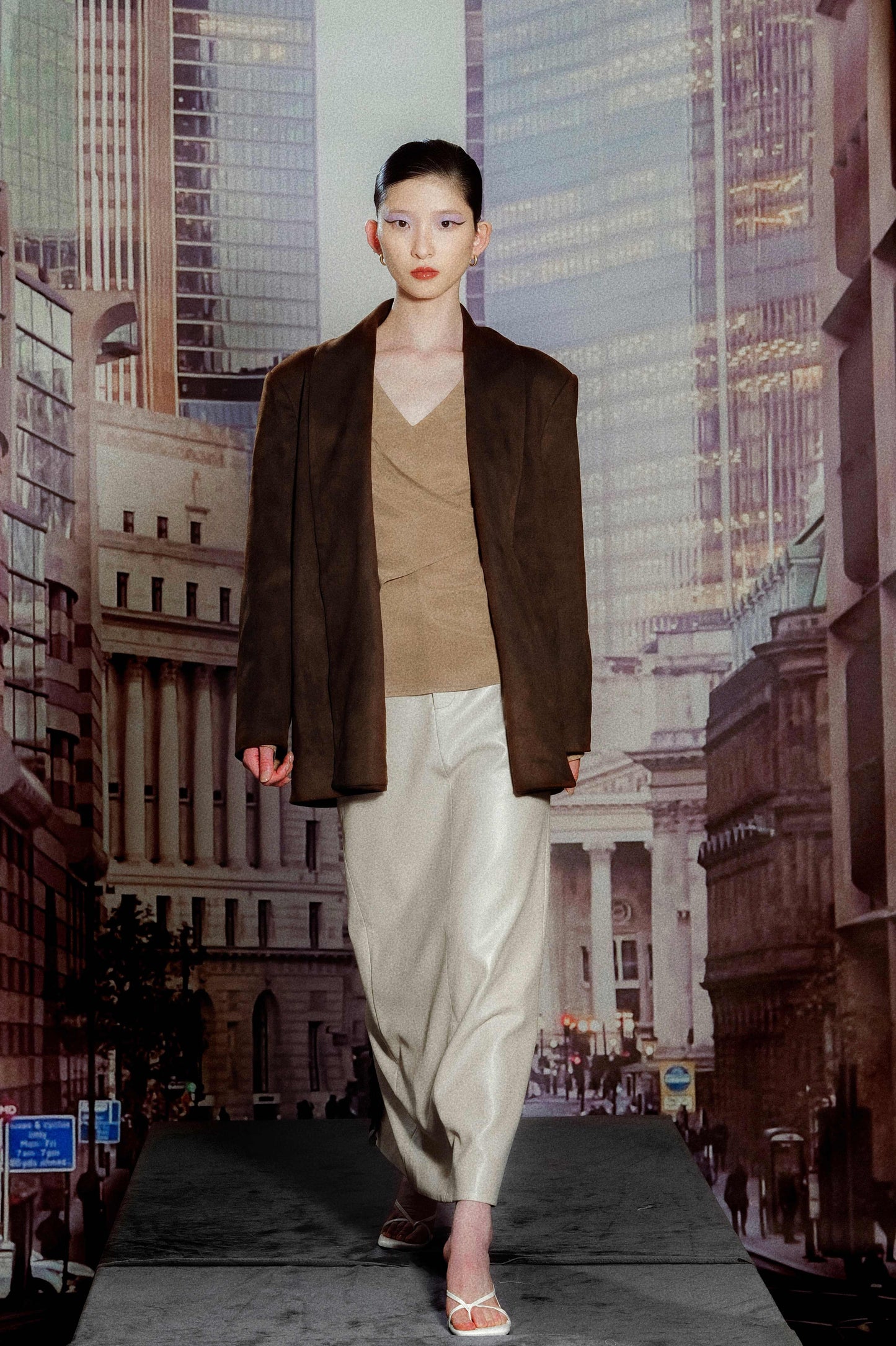 Model wearing wide drop shoulder suede blazer