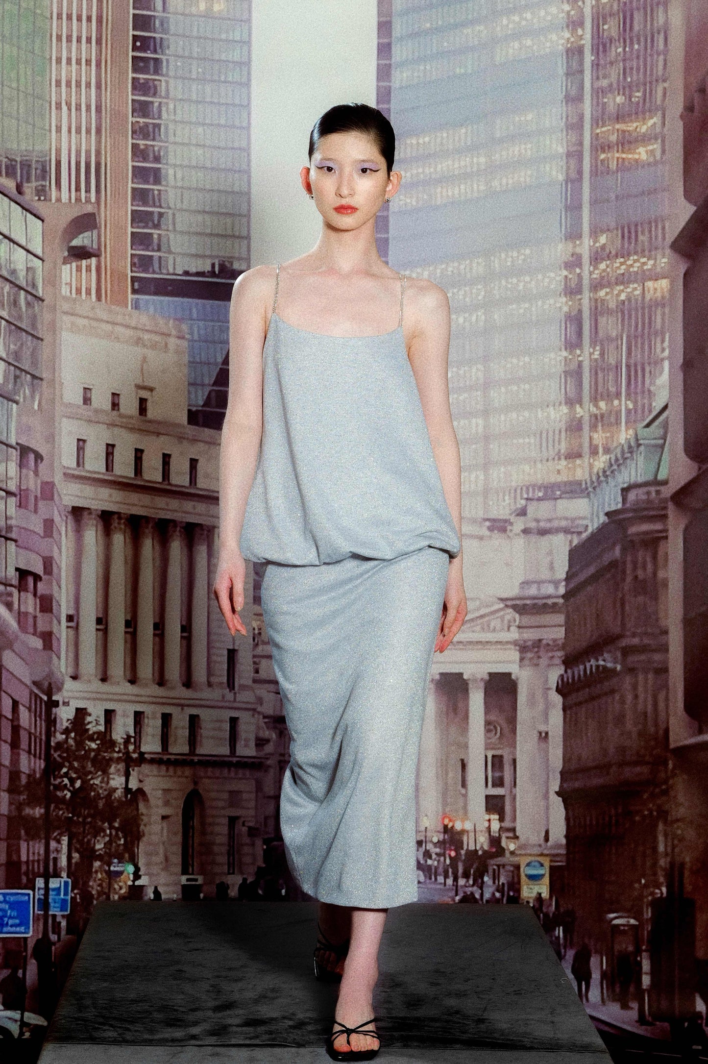 Model in blue silver camisole and fitted
skirt