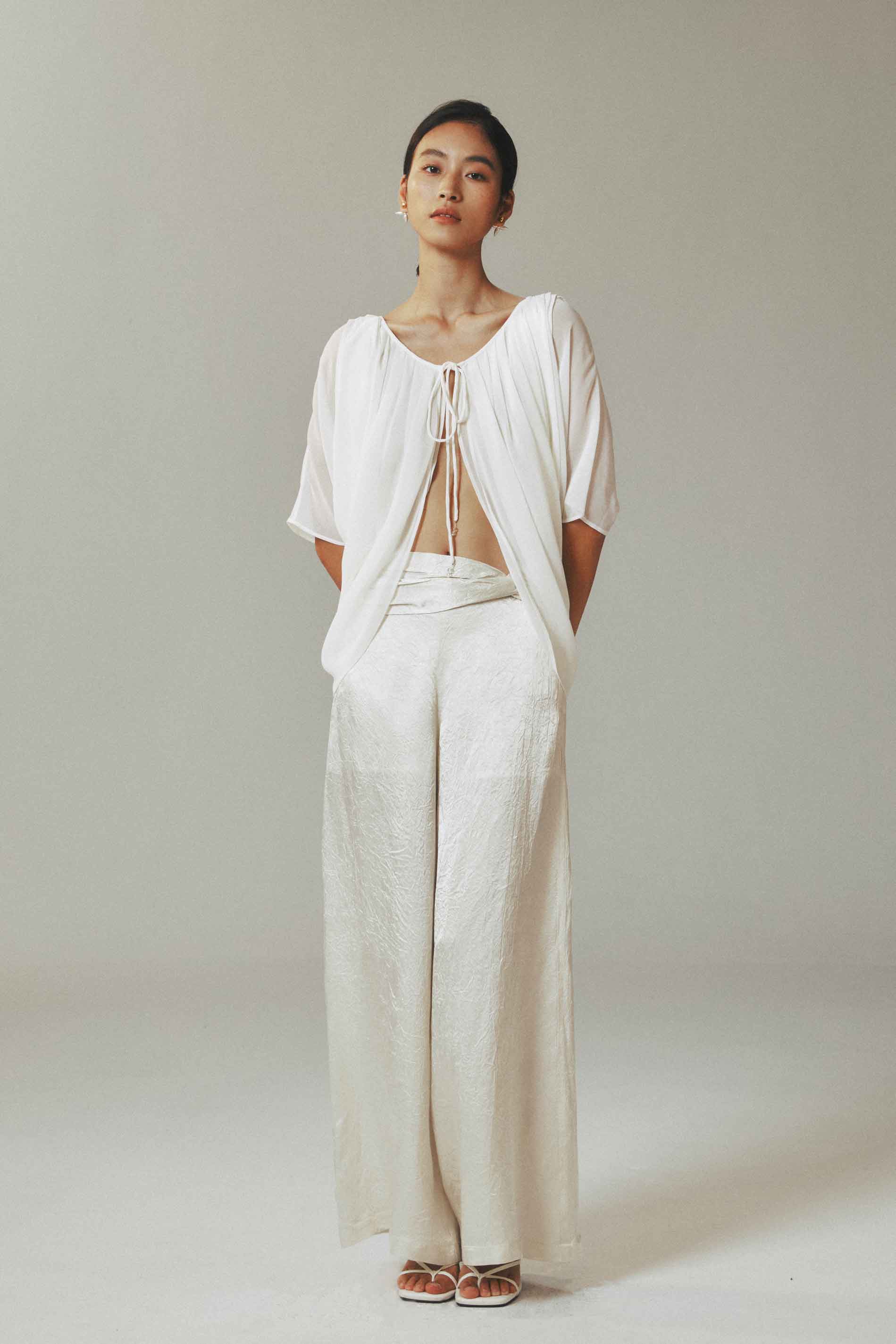 Model wearing light cardigan with
water-drop beads and half sleeves