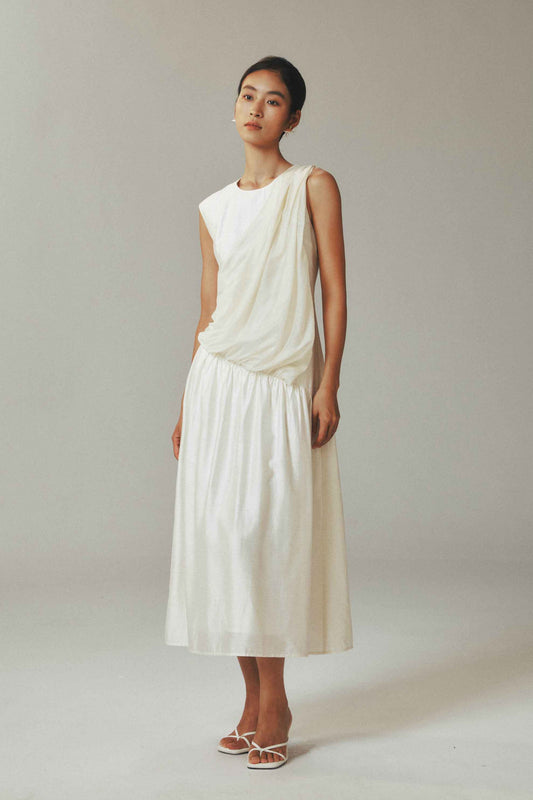 Model in a long breezy sleeveless dress
in linen tencel blend
