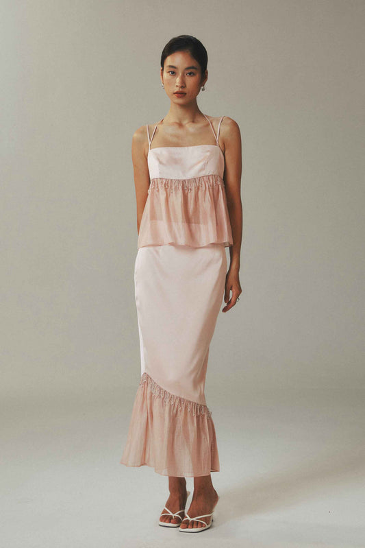 Model wearing halter crop top and skirt with
crystal bead detailing in ice-silk fabric