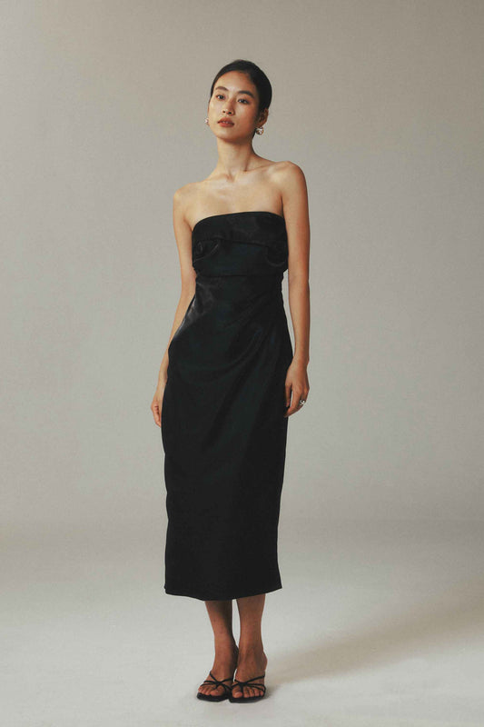 Model wearing black satin maxi sheath
dress with waist pleats