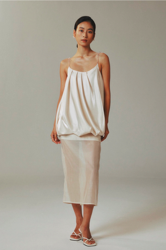 Model wearing gold satin half skirt with sheer tencel overlay