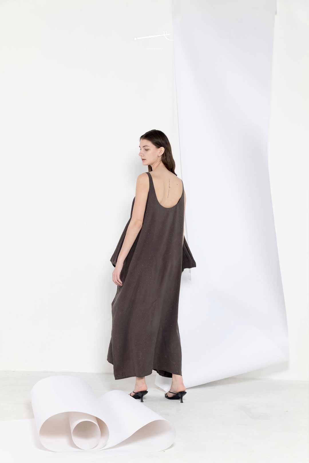 Model in a long breezy sleeveless dress
in linen tencel blend