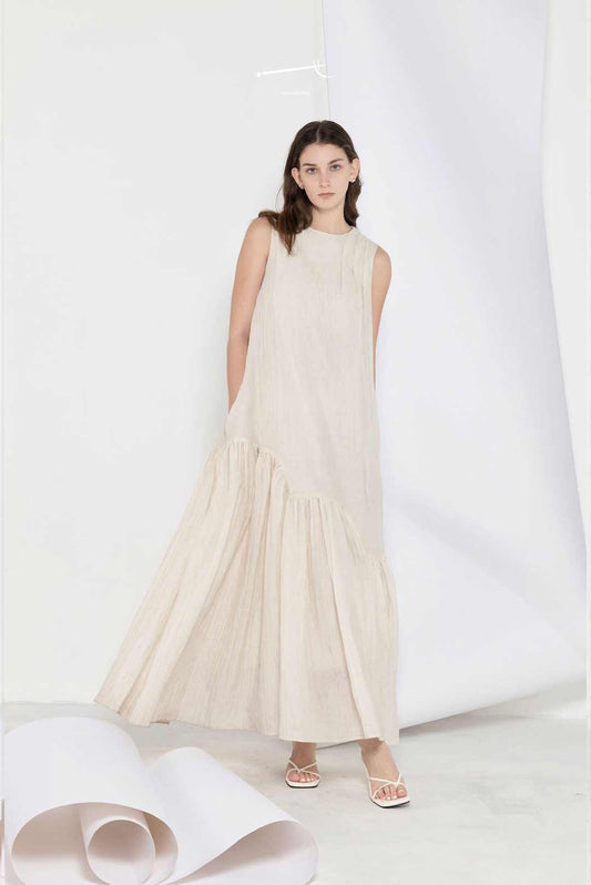 Model wearing beige loose-fitting maxi
dress with wide hem
