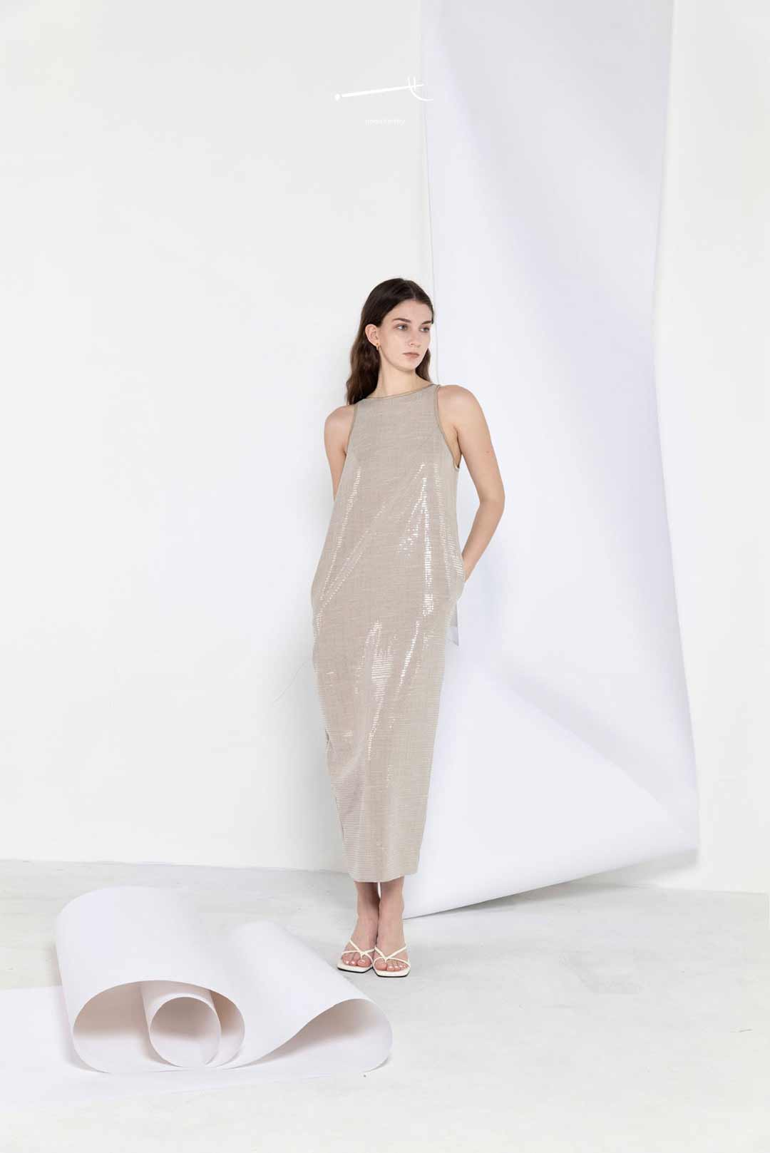 Model wearing cocoon-shape sequin
maxi dress with side slit
