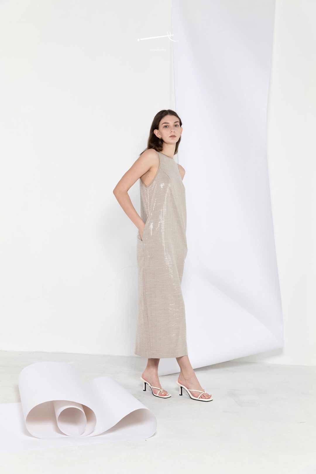 Model wearing cocoon-shape sequin
maxi dress with side slit